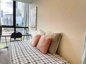 a bedroom with a bed with two pillows on it at Harbour Haven Sleep 7 Free Parking Free Tram to CBD in Melbourne +21 photos