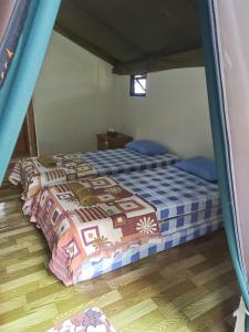 a bedroom with two beds in a room at Glamping Camphills in Gunungpicung