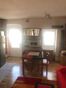 a living room with a table and a microwave at Appartement Studio 1 Punat Insel Krk in Punat +20 photos