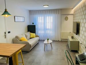 a living room with a couch and a table at La Aduana - The Lodging Experience in Astorga