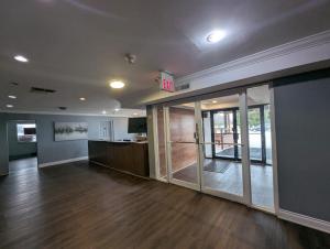 an empty office with a lobby with sliding glass doors at London Residency Inn in London