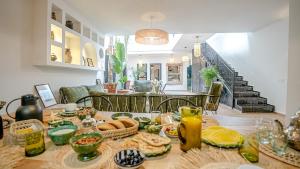 a table with food on it in a living room at Riad Al Jadd - 5 Bedrooms - Pool - Breakfast in Marrakesh
