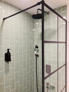 a shower with a glass door in a bathroom at La Aduana - The Lodging Experience in Astorga +91 photos