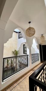 a building with a balcony with a black railing at Riad Al Jadd - 5 Bedrooms - Pool - Breakfast in Marrakesh