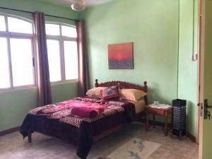 a bedroom with a bed in a room with windows at Escale Gris Gris, breathtaking views and location! in Souillac +11 photos