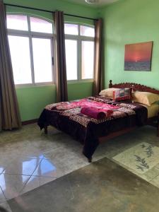 a bedroom with a large bed in a room with windows at Escale Gris Gris, breathtaking views and location! in Souillac