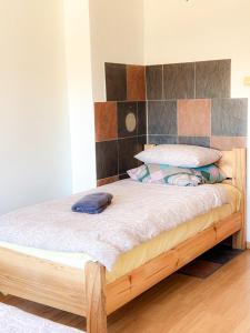 a bed in a room with a wooden frame at Mājīgs dzīvoklis Aizputē in Aizpute