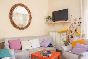 a living room with a couch and a mirror at La Casa dei Panorami in Castelsaraceno