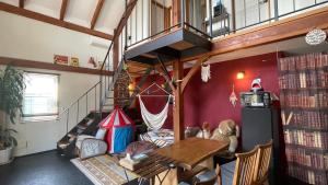a living room with a table and a staircase at B&BHOUSE FAM in Ichinomiya