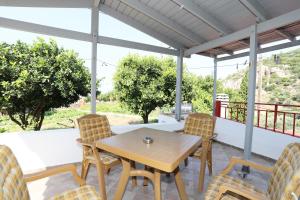 a table and chairs on a patio with a view at Katina Balos Rooms-Studios in Koumeika +43 photos