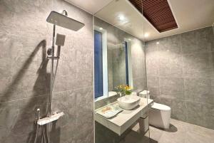 a bathroom with a sink and a toilet and a shower at PALM Minh Chau Hotel-Only for Vietnamese in Quang Ninh +23 photos