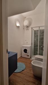 a bathroom with a sink and a microwave at House 100 meters from the beach in Marina di Ragusa +24 photos