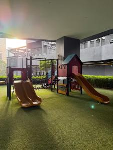 a playground with two slides in a building at Star Residence KLCC By BluekeyKL in Kuala Lumpur
