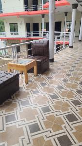 a patio with a couch and a coffee table on a building at Balakot View Hotel in Bauli