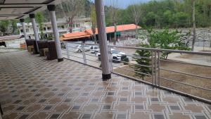 a train station with a car parked in a parking lot at Balakot View Hotel in Bauli