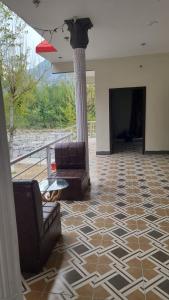 a living room with two chairs and a pillar at Balakot View Hotel in Bauli +14 photos