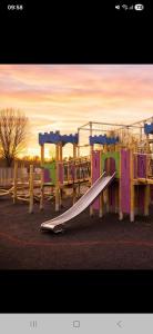 a playground with a slide in a park at Highfield Grange Holiday Park in Little Clacton