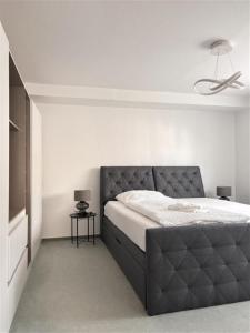 a bedroom with a bed and a ceiling fan at Deluxe Apartment Ella in Backnang +2 photos