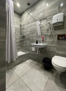 a bathroom with a toilet and a sink and a shower at Rynek 7 in Katowice +28 photos