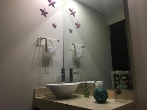 a bathroom with a sink and pink stars on the wall at Napoles Condo Suites in Mexico City +49 photos