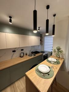 a kitchen with a wooden table with plates on it at Urban Studio 018 in Niš