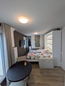 a hotel room with a bed and a table and a table at Studio au coeur de Plouharnel in Plouharnel +1 photo