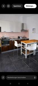 a kitchen with a wooden table and white chairs at Casa Zeralda, privater Pool in Budoni