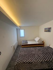 a bedroom with two beds and a window at Antic Apartman in Bor