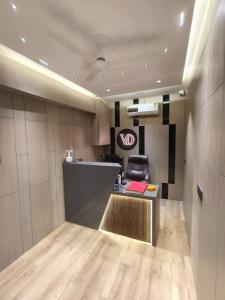 an office with a desk and a chair in a room at Hotel VD Rooms Althan in Surat