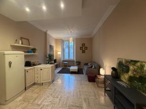 a kitchen and living room with a white refrigerator at L' Appartamento Experience in Tivoli