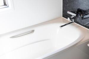 a bathroom sink with a faucet next to a window at YAMAKATSU Hotel in Dazaifu +45 photos