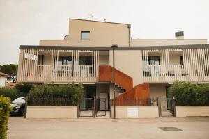 a white building with balconies on top of it at Villa Alcova in Caorle