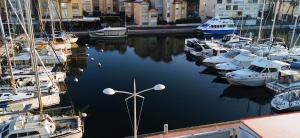a bunch of boats are docked in a harbor at Merveilleuse Port - Piscine - Plage - Climatisation - Commerces in Gruissan +14 photos