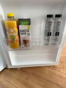 an open refrigerator filled with drinks and juice at Arya Thermalis in Baile Felix