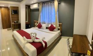 a bedroom with a bed with two towels on it at Shanti Regency in Guwahati