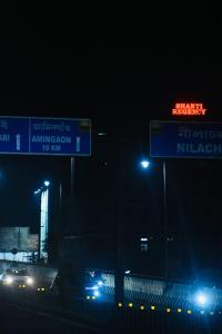 a street sign on a highway at night at Shanti Regency in Guwahati
