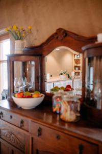a wooden dresser with a bowl of fruit on it at Smykowe Doły in Wilczyce