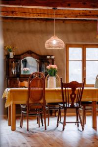 a dining room with a yellow table and chairs at Smykowe Doły in Wilczyce