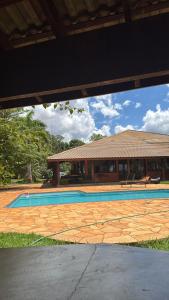 a swimming pool in front of a house at Chacara Vila Bella in Bebedouro