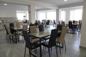 a dining room with tables and chairs in a restaurant at Aventus Hotel in Akhaltsikhe