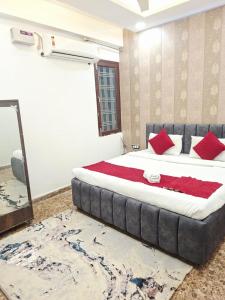 a bedroom with a large bed with red pillows at Sukoon in Jāmb