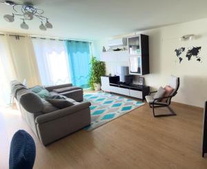 a living room with a couch and a chair at Casa Ponte do Mar in Sines
