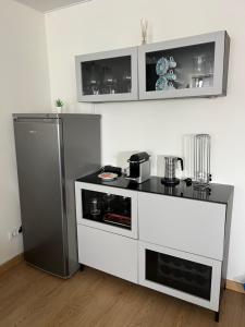 a kitchen with a refrigerator and a counter at Casa Ponte do Mar in Sines