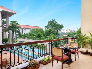 a balcony with a table and chairs and a view at Jaypee Greens Golf and Spa Resort in Greater Noida