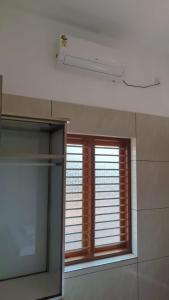 a bathroom with a window with blinds and a mirror at Grand Beach Villa in Kannur +61 photos
