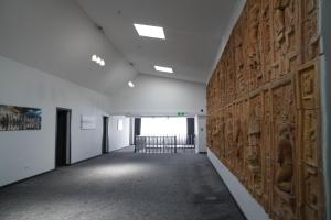 an empty hallway with a wall of wood panels at Aventus Hotel in Akhaltsikhe