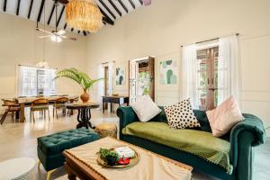 a living room with a couch and a table at Casa Century Anjuna in Anjuna