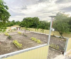a garden with a fence and some plants at Eco Homes in Panglao Island