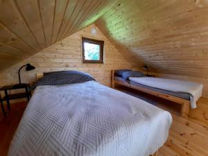 a bedroom with two beds in a wooden cabin at Physio House Sokolik in Komarno +7 photos