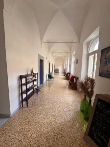 a hallway in a building with white walls and ceilings at Relais il Chiostro Historic Courtyard & Panoramic Terrace near Sorrento in Massa Lubrense +74 photos